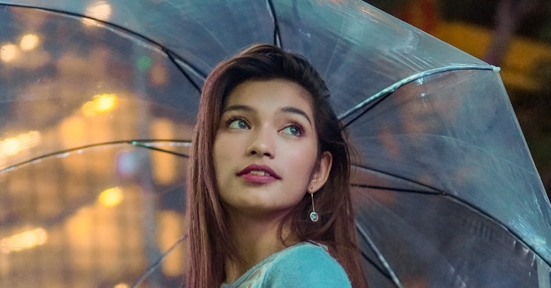 smiling filipino woman under umbrella