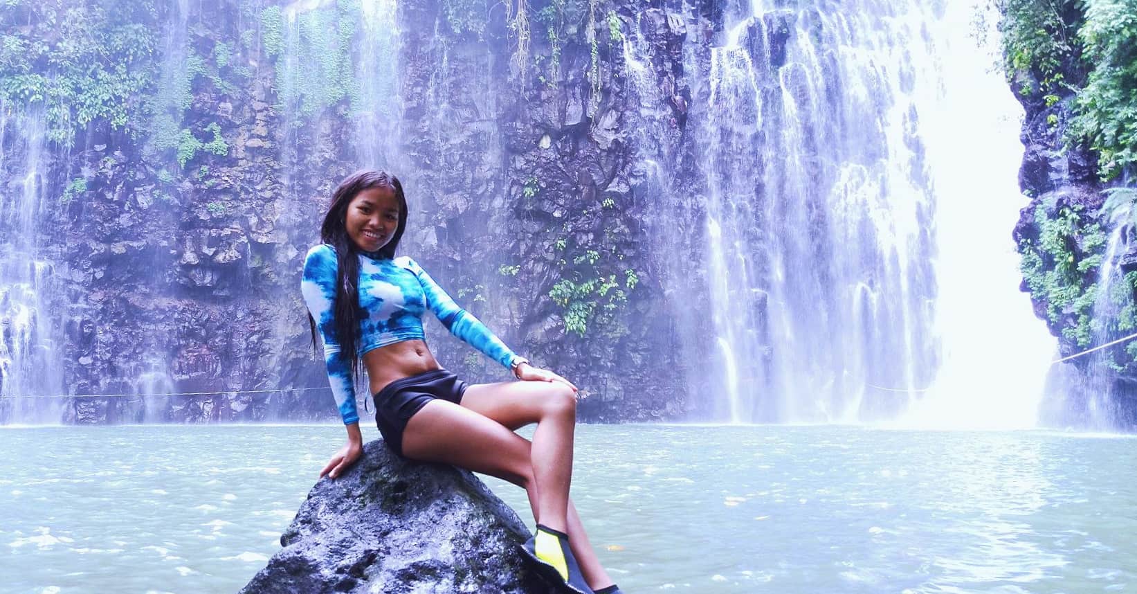 Beautiful Philippines girl near waterfall